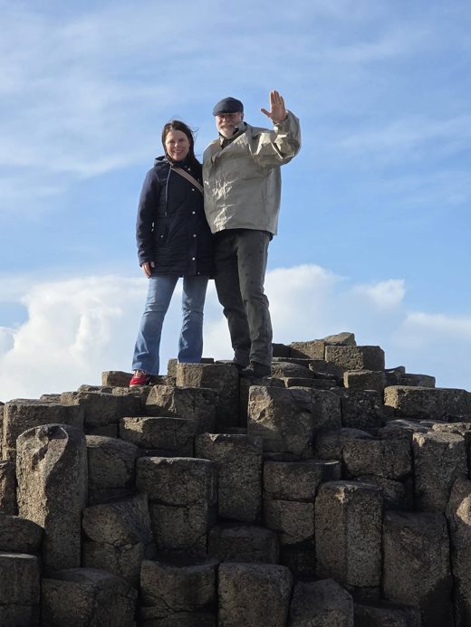 Jon and his wife standing on the basalt columns of the Giant&rsquo;s Causeway